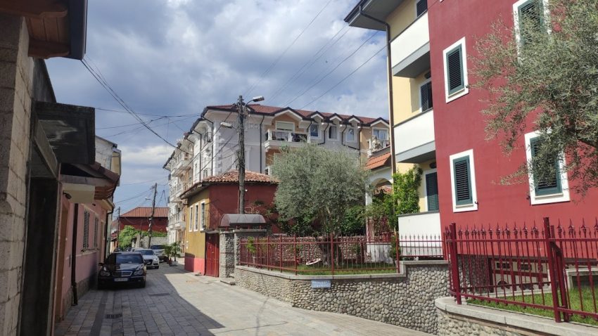 a street with cars and buildings along it